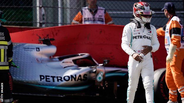 Lewis Hamilton walks away from his car