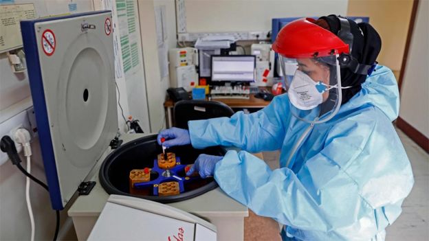 A lab technician loads a centrifuge machine with blood samples at a hospital in Tehran, Iran (1 March 2020)