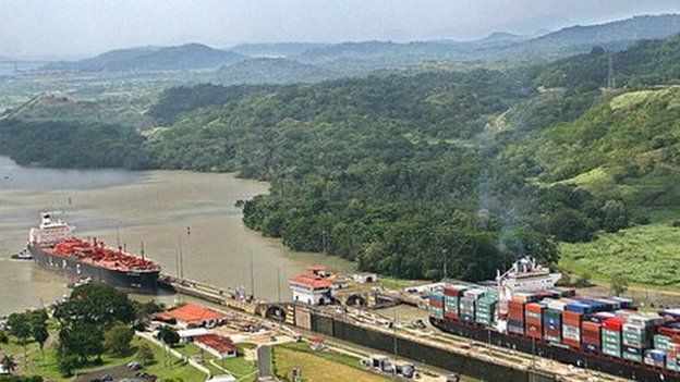 Ships pass through the Panama Canal's Pedro Miguel locks