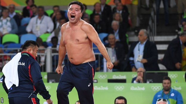 Mongolia's Mandakhnaran Ganzorig's coach reacts after the judges announced that Uzbekistan's Ikhtiyor Navruzov won following a video replay in their men's 65kg freestyle bronze medal match