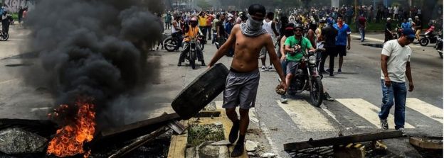 Anti-government activists build a barricade in Valencia