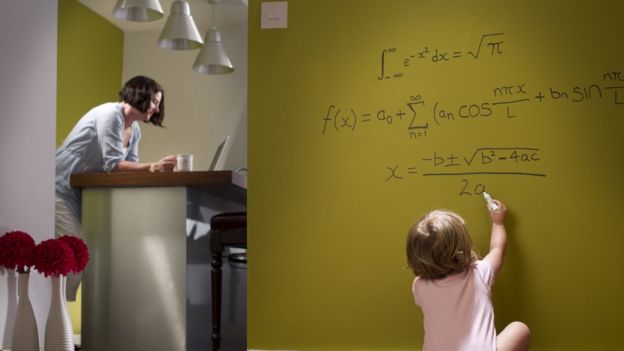 Child writing on blackboard