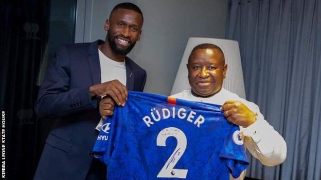 Chelsea's Antonio Rudiger (left) hands over a signed shirt to Sierra Leone President Julius Maada Bio