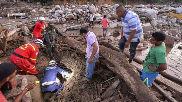 Rescuers seek people among the rubble left by mudslides following heavy rains in Mocoa, Putumayo department, southern Colombia on April 1, 2017.