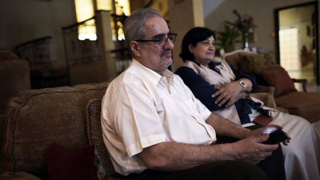 Ibrahim Sharif, chief of the Waed secular group, sits with his wife Farida Ghulam (R) at their home in the village of Tubli, south of Manama, on 20 June 2015