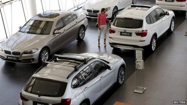 Woman looking round BMW showroom