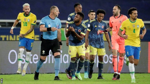 Colombia players confront the referee during their Copa America game against Brazil