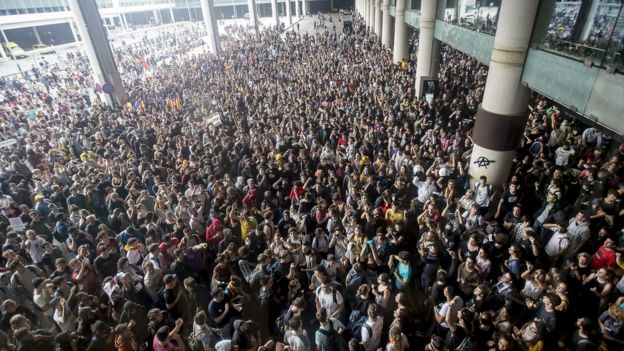 Thousands of Catalonia pro-independence activists occupy Barcelona airport.