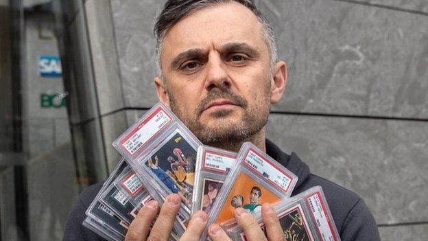 Gary Vaynerchuk holds a collection of his sports card collection