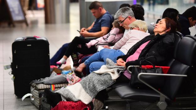Passengers sleep in the terminal