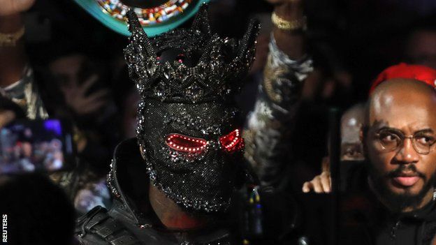 Deontay Wilder wearing a mask as he makes his entrance to the ring