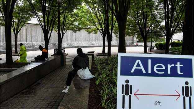 A sign displays social distancing rules at a park in downtown Atlanta, Georgia, on 23 April
