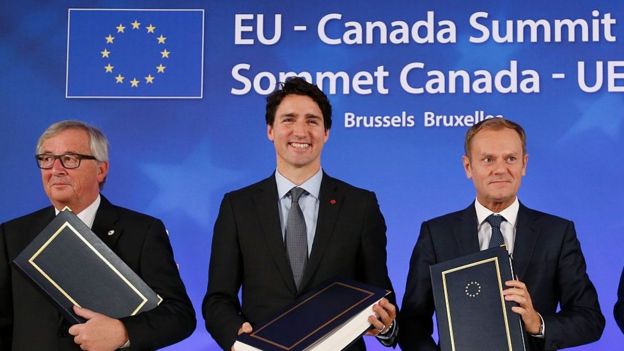 European Commission President Jean-Claude Juncker, Canadian Prime Minister Justin Trudeau and European Council President Donald Tusk pose after signing the CETA trade deal during the EU-Canada summit meeting in