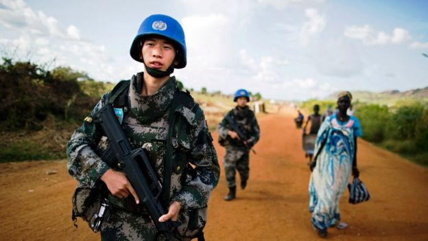 Chinese peacekeeping troops walk along a road in South Sudan