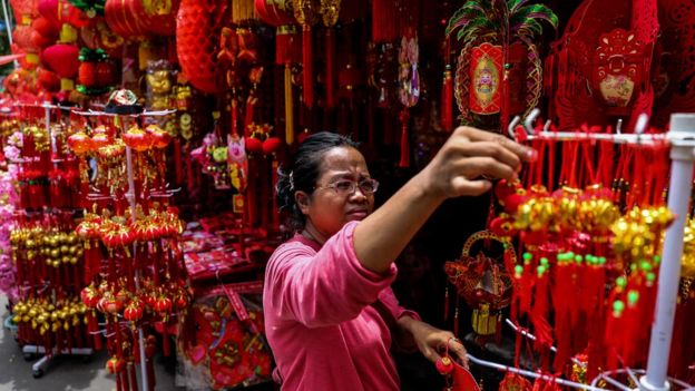 A woman at a shop selling Lunar New Year decorations in Jakarta, Indonesia