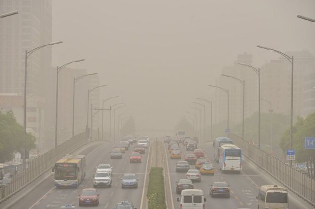 Vehicles are seen on roads during a dust storm in Beijing, China, 4 May 2017
