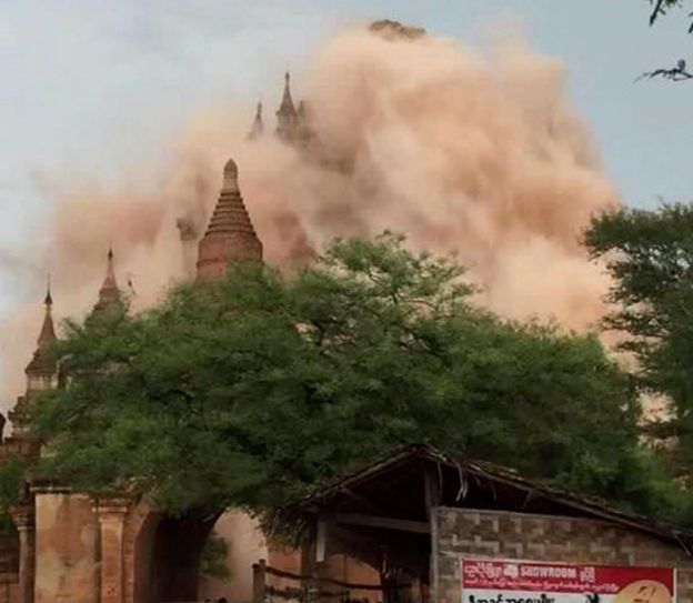 24 August 2016 photo showing a huge cloud of dust coming from a temple during the earthquake.