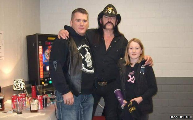Lemmy poses with Mr Hahn and his daughter, with her arm in plaster (which he signed)
