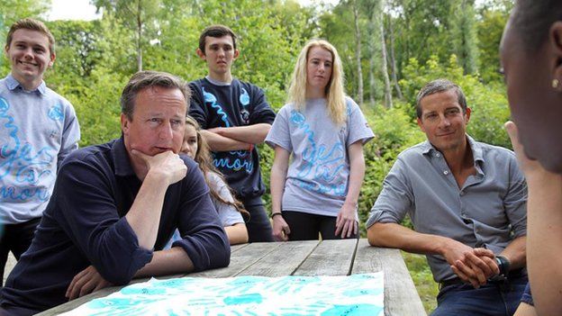 David Cameron and Bear Grylls with young volunteers