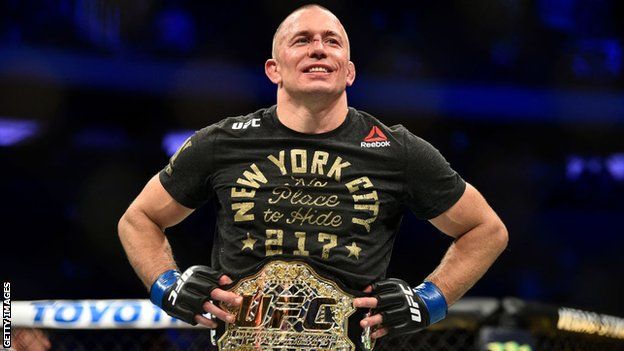 Georges St-Pierre celebrates beating Michael Bisping