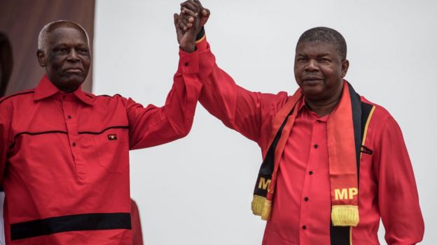 Angolan President and The People's Movement for the Liberation of Angola President Jose Eduardo dos Santos and MPLA candidate to the presidency Joao Lourenco hold hands during the closing campaign rally in Luanda, on August 19, 2017.