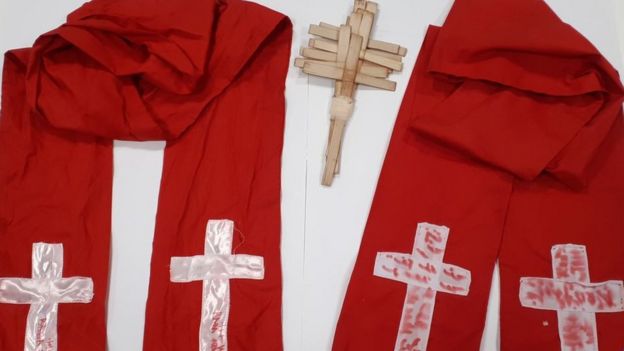 Red robes with homemade crosses on them