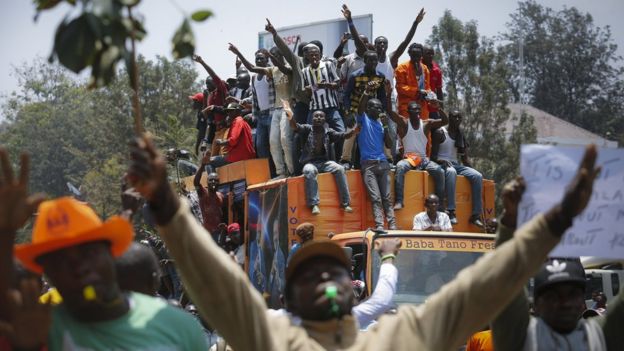 Supporters of the opposition coalition The National Super Alliance (NASA) and its presidential candidate Raila Odinga sit on top of a truck during their protest against the country