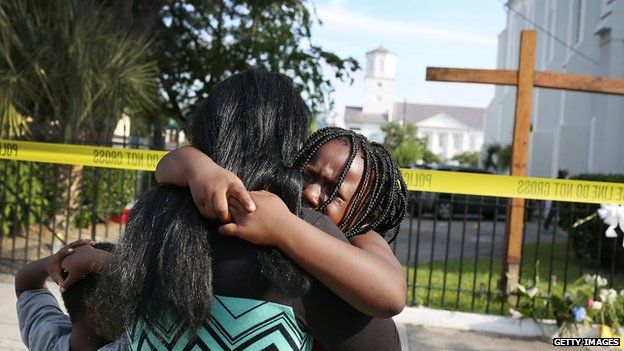 Mourners gathered outside the Emanuel African Methodist Episcopal Church in Charleston after a mass shooting that killed nine people.
