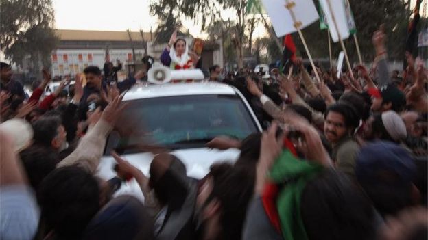 Former Prime Minister Benazir Bhutto waves from her car just seconds before being attacked on December 27, 2007 in Rawalpindi, Pakistan.