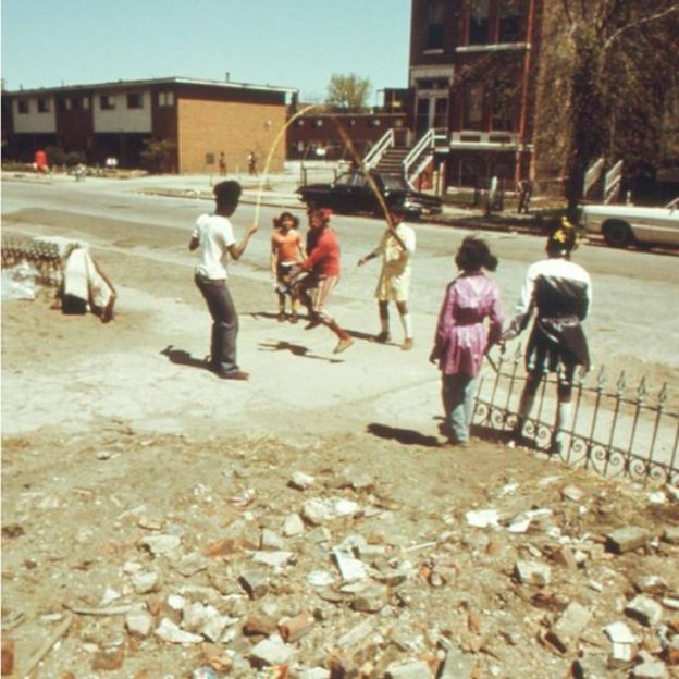 African-American children play outside the Ida B Wells Homes, one of Chicago's oldest housing projects, Illinois, May, 1973