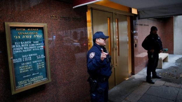 New York Police Department officers stand guard at Fifth Avenue Synagogue in New York, December 11, 2019