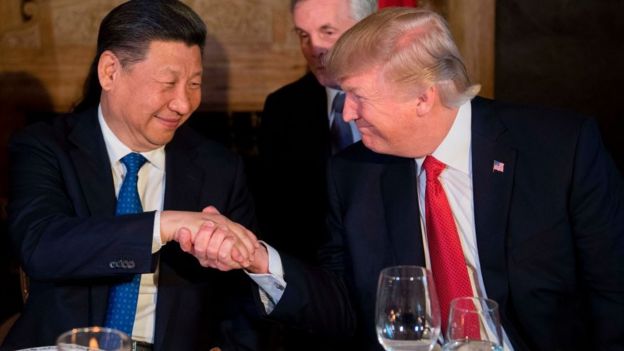 Donald Trump shakes Chinese President Xi Jinping's hand.