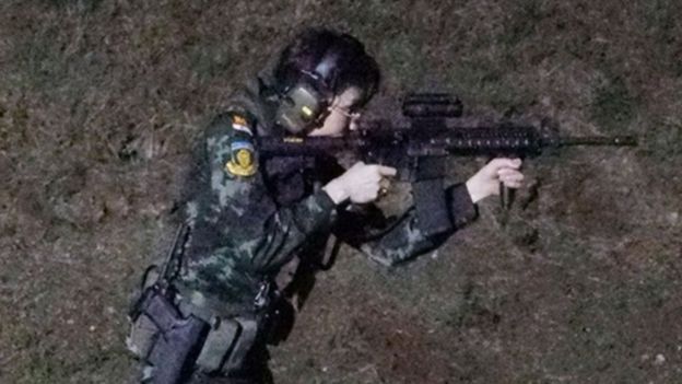 Sineenat Wongvajirapakdi aims a weapon at a firing range