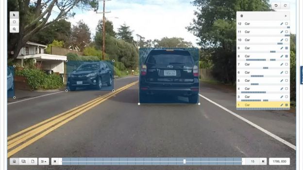 Computer screen showing cars in a street