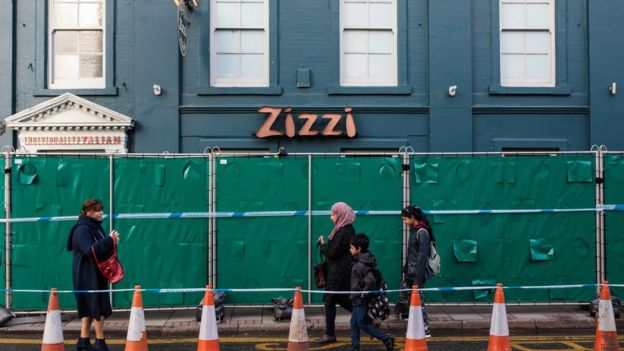 People walk past a Zizzi restaurant which has been closed as investigations continue into the poisoning of Sergei Skripal