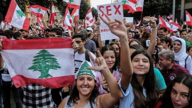 Protesters carry placards during a protest in front the Government palace in downtown Beirut, Lebanon