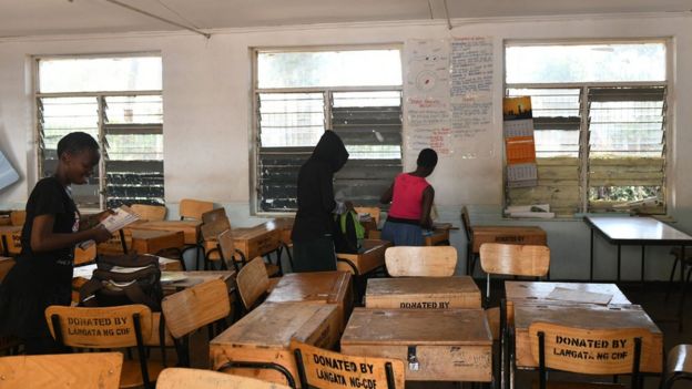 School children pack their books to take home, following a directive by the Kenyan government to suspended learning