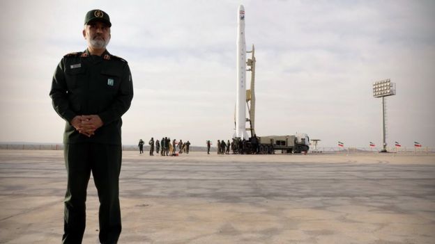 IRGC Aerospace Force commander Brig-Gen Amir-Ali Hajizadeh stands near the satellite launcher