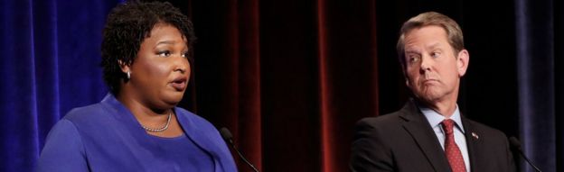 Democratic gubernatorial candidate for Georgia Stacey Abrams speaks as Republican candidate Brian Kemp looks on during a debate in Atlanta