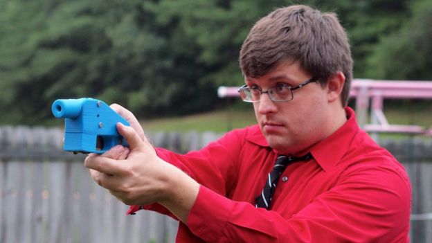 Man points a 3D printed pistol