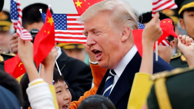 Donald Trump is greeted by Chinese children and soldiers on his arrival in Beijing