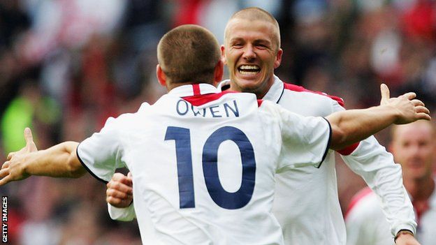 David Beckham celebrates scoring against Wales with Michael Owen