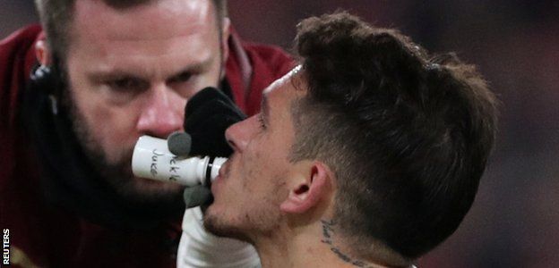 Arsenal's Lucas Torreira drinks from a bottle labelled 'pickle juice'