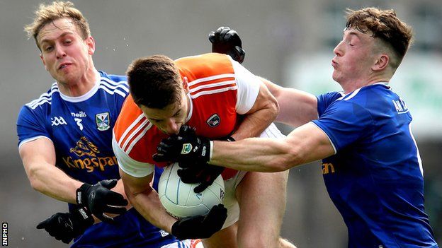 Cavan's Padraig Faulkner (left) was black-carded for this chellange on Niall Grimley