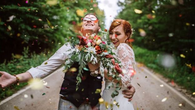 Married couple being showered in confetti