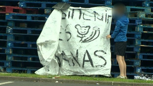 A racist banner directed at Celtic footballer Scott Sinclair was photographed on a bonfire in east Belfast