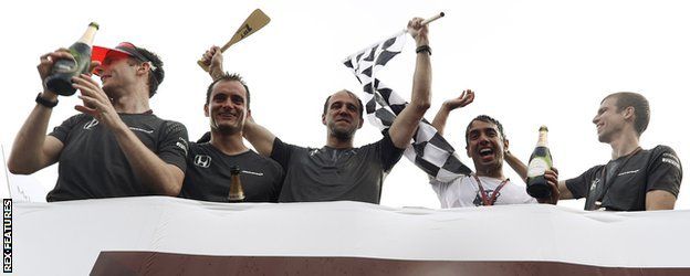 The McLaren team celebrate winning the inter-team raft race