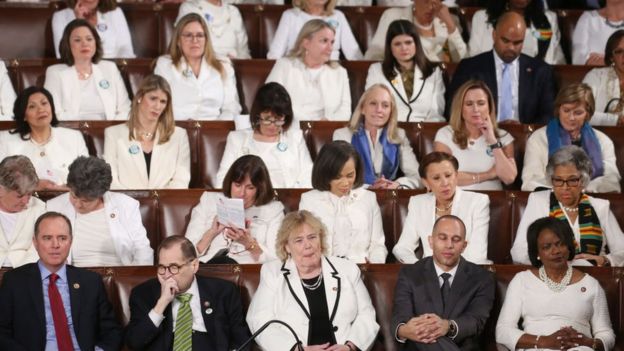 Democratic members of Congress listen to the State of the Union address