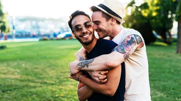Two gay men hugging