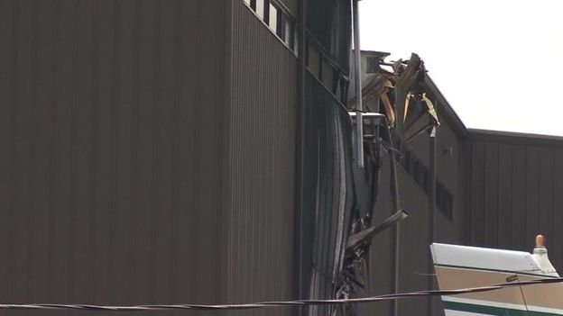 A hole in the side of an airport hangar in Texas, US